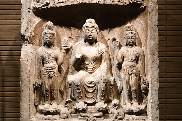 Buddha with Two Attendants in a Niche (704)
