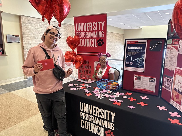 Disala picks up a lollipop and letter at uPC’s Valentine’s Day table.