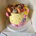 Buttercream birthday cake with macarons and cascade of flowers