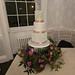 Small three tiered wedding cake with a selection of flowers