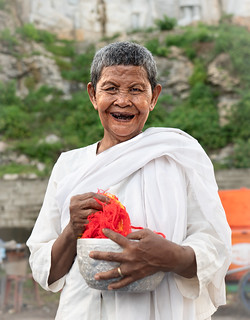 In Cambodia chewing Betel Nuts leaves a stain on the teeth which is a sign of beauty.  Its also really addictive which may explain why this lovely lady was so jolly
